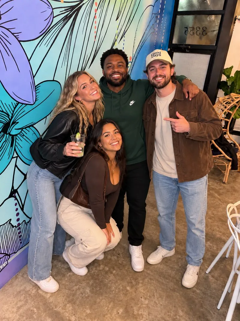Friends gathered by the tropical mural at Nala’s Party Room in Irving Park