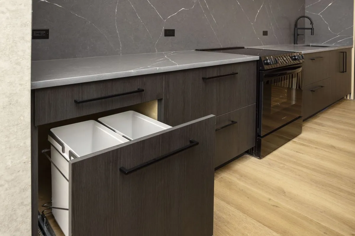 Pull-out trash and recycling drawer in the kitchen