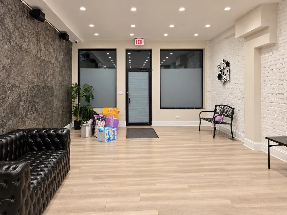 Party gifts by the entrance in the open space with the stone accent wall and black leather sofa